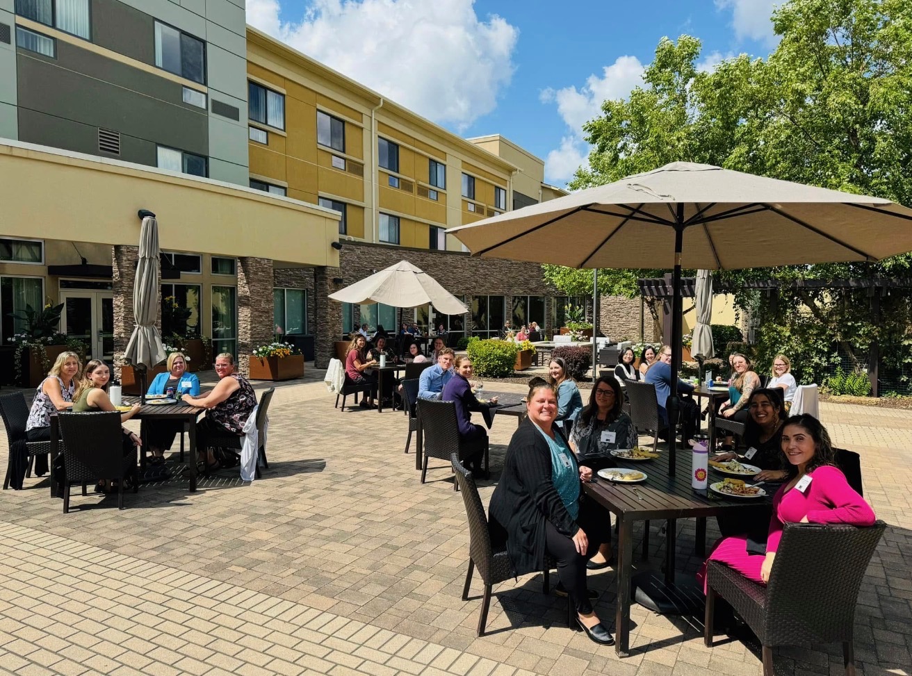 Guests dining outdoors in the landscaped courtyard